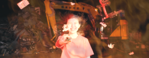 Japanese teenager girl laughs and points an object toward camera.