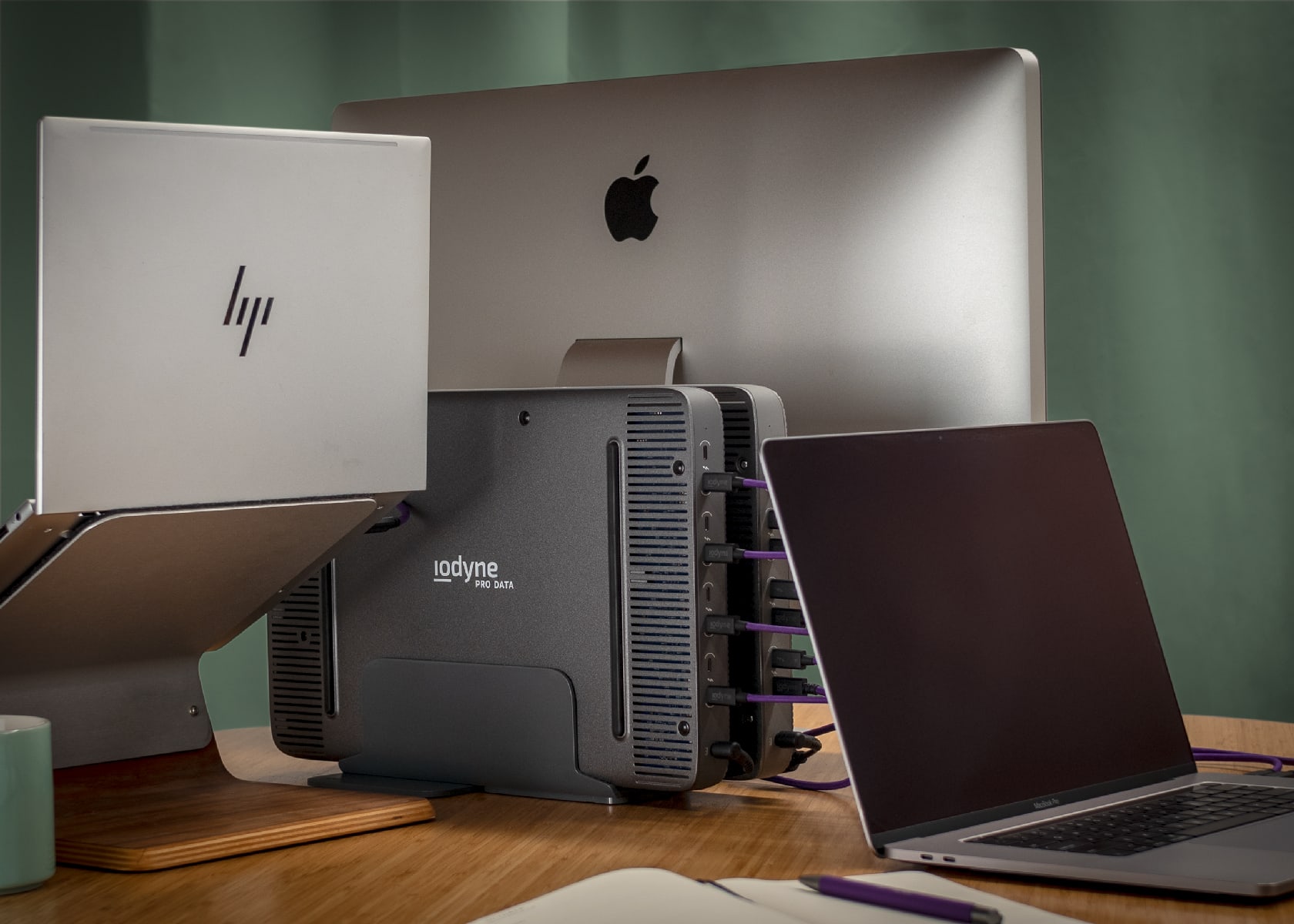 HP laptop, Mac desktop, and Mac Book connected to two sets of Pro Data hard drives.