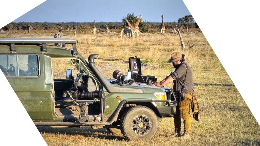 Wildlife filmmaker in remote African camp with iodyne Pro Data storage device on location shoot