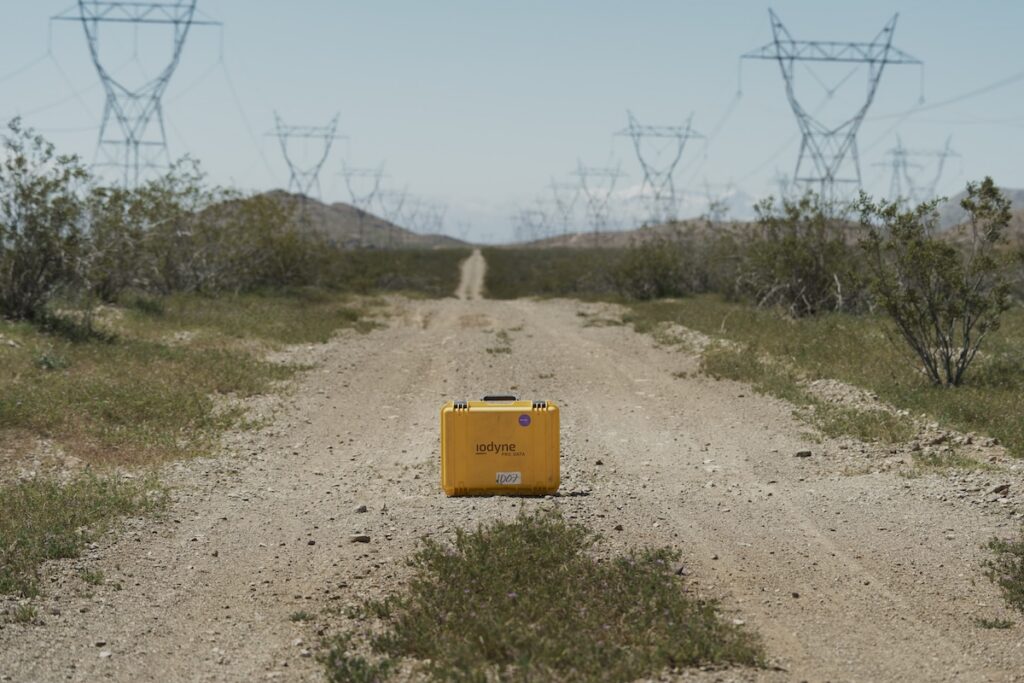 iodyne Pro Data yellow pelican case on a dirt road