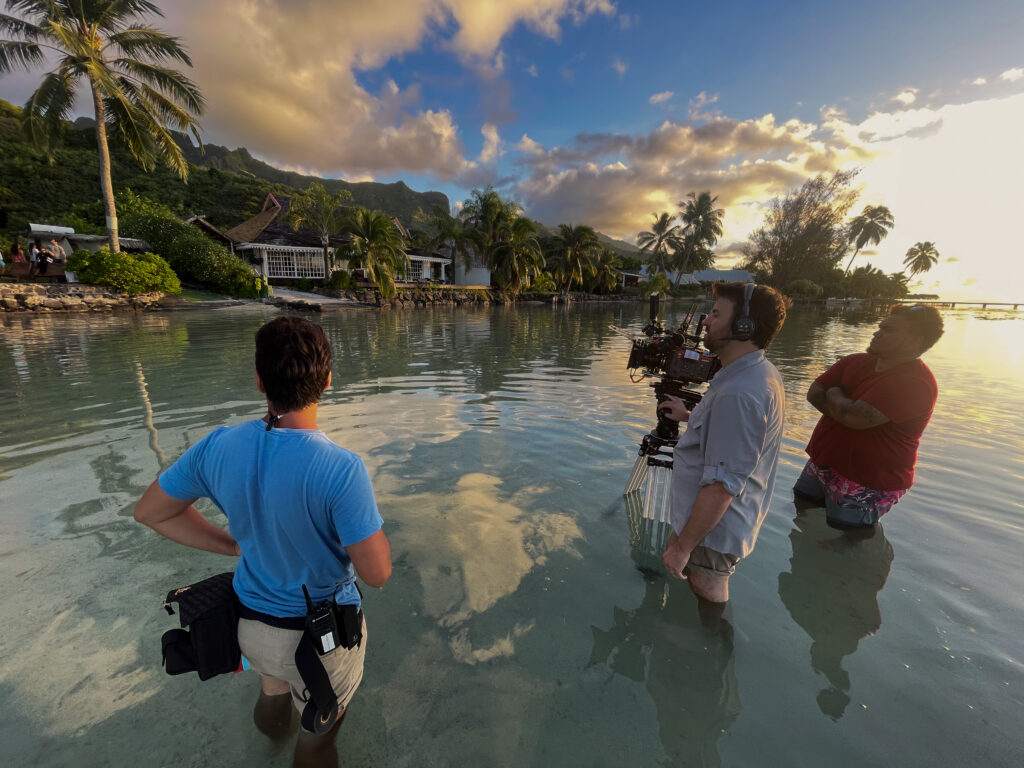 Filmmaker in remote island landscape with iodyne Pro Data storage device on location shoot