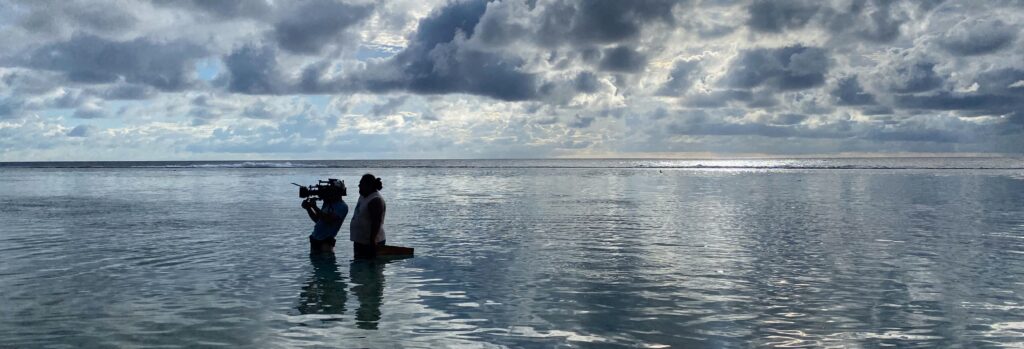 Filmmaker in remote landscape with iodyne Pro Data storage device on location shoot