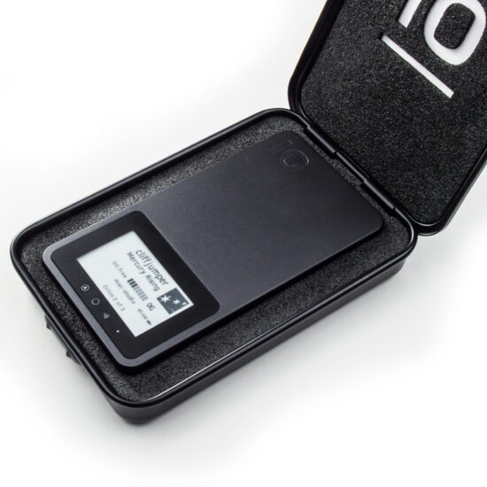A small black steel case is hinged open on the top short-side to reveal foam snugly surrounding Pro Mini, which sits 0.5mm proud for easy removal. The lid is also padded, with an iodyne "io" glyph cut out