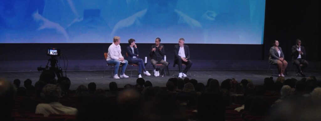 four panelists and ASL translators on a stage